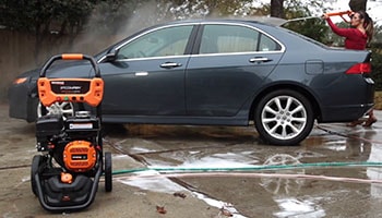 A woman washes a car.