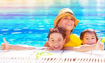 Mother and her kids in the pool.
