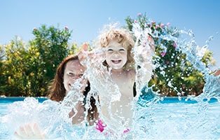 Woman and a girl enjoy the pool.